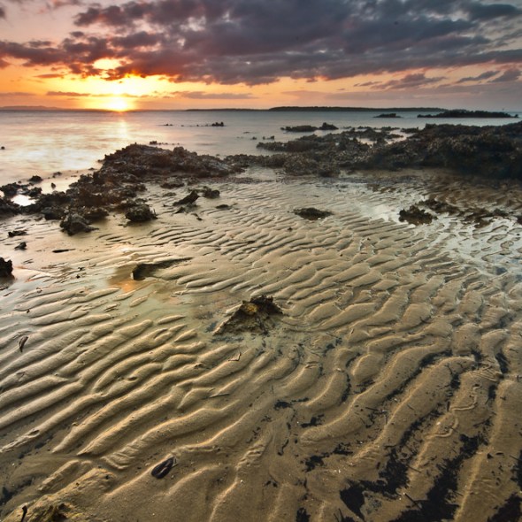 sand pattern and rocks sunset