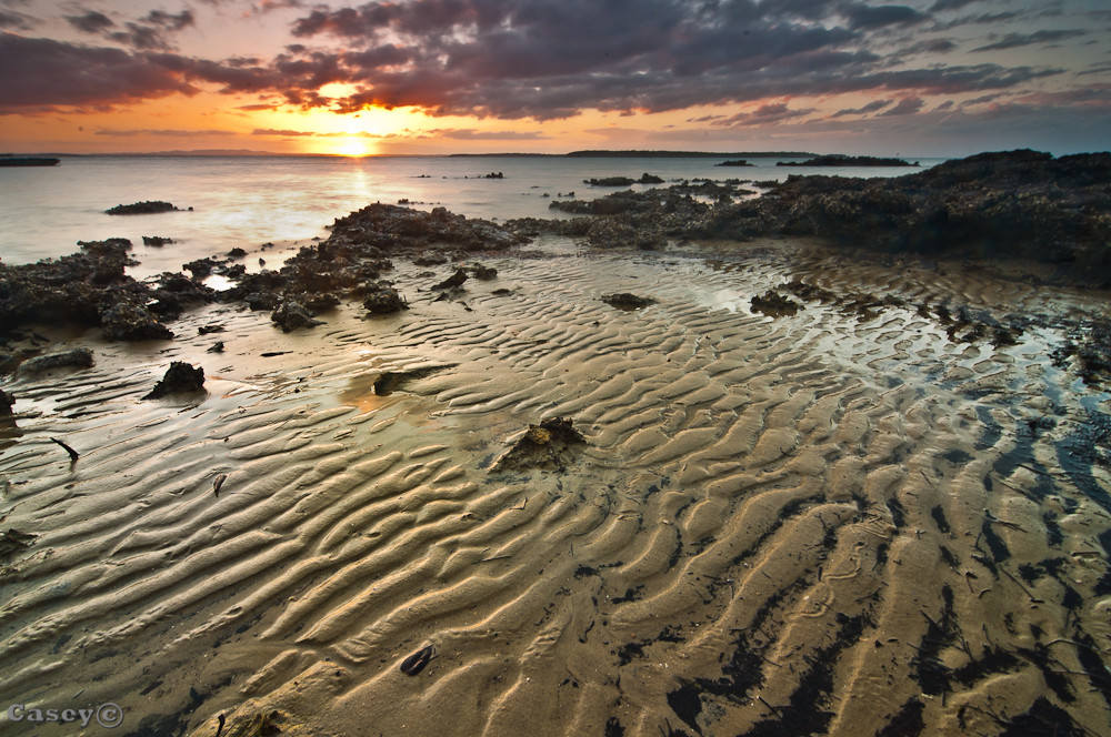 sand pattern and rocks sunset
