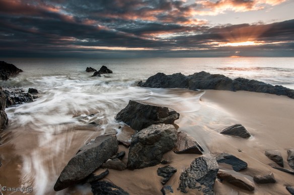 Topical sun rays sunrise at Ellis beach rocks